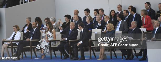 President Donald Trump talks with French President Emmanuel Macron next to US First Lady Melania Trump , French Defence Minister Florence Parly ,...