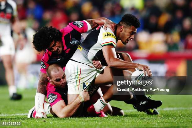 Waqa Blake of the Panthers is tackled by Simon Mannering and James Gavet of the Warriors during the round 19 NRL match between the New Zealand...