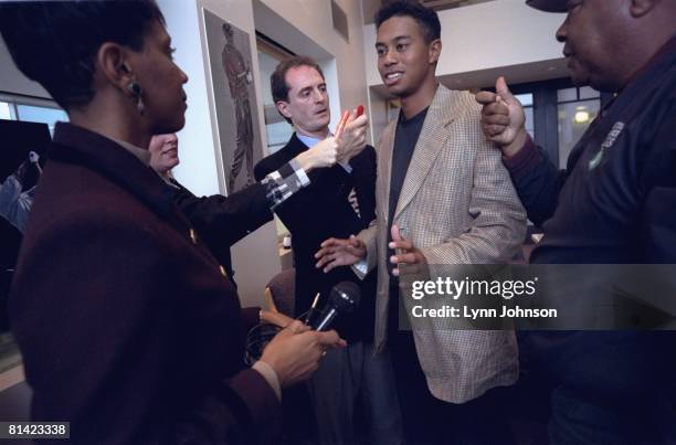 Golf: Casual portrait of Tiger Woods getting approached by media expert Denise Harrington , father Earl Woods , and others during mock media assault...