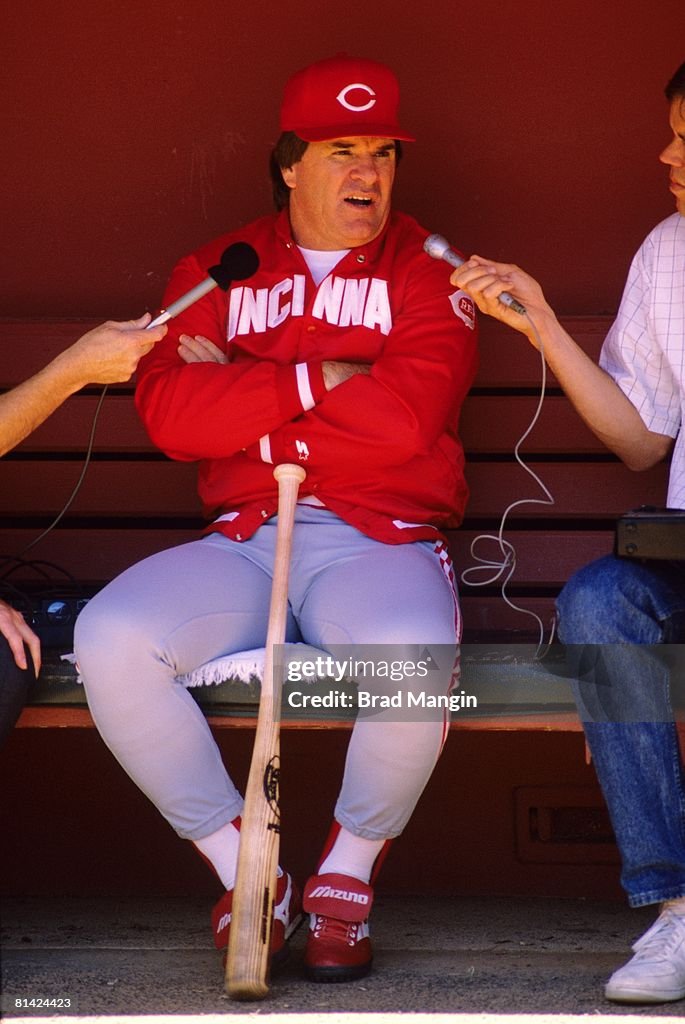 Red Roses Manager Cincinnati Reds manager Pete Rose in dugout with media during game vs ...
