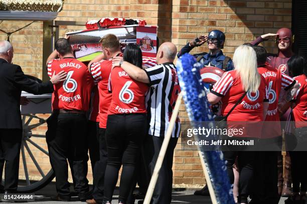 Mourners dressed as super heroes salute Bradley Lowery's coffin as it is carried into St Joseph's Church on July 14, 2017 in Hartlepool, England....