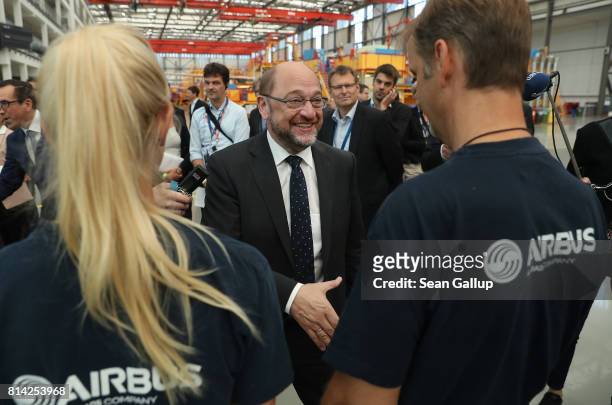 German chancellor candidate and head of the German Social Democrats Martin Schulz greets workers while visiting an assembly hall of the A320...