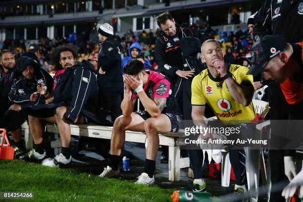 Shaun Johnson of the Warriors reacts on the bench after coming off with an injury during the round 19 NRL match between the New Zealand Warriors and...
