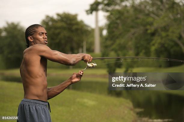 Football: Closeup portrait of Oakland Raiders Randy Moss fishing in stream behind his home, Boca Raton, FL 4/20/2005