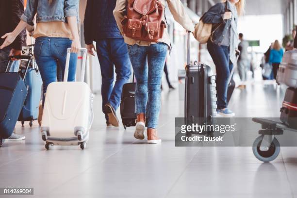 passengers walking in the airport terminal - airport stock pictures, royalty-free photos & images
