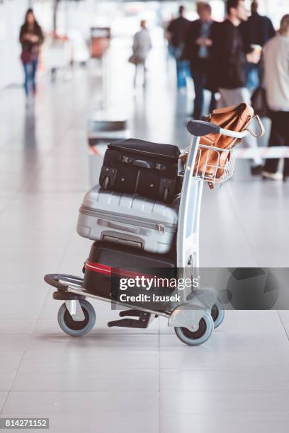 airport luggage trolley with suitcases - luggage trolley stock pictures, royalty-free photos & images