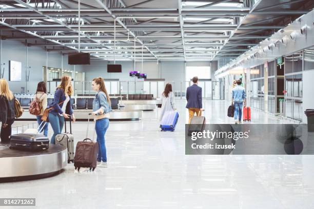 passengers walking to board flight in airport - baggage claim stock pictures, royalty-free photos & images