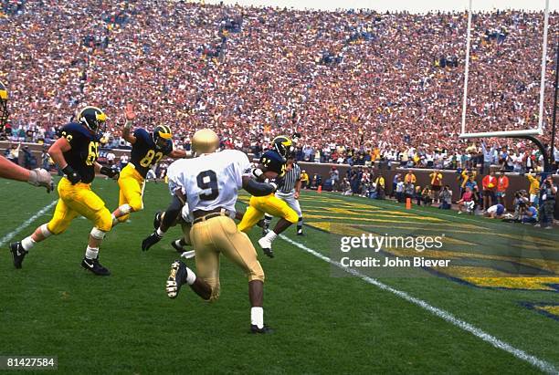 College Football: Michigan Desmond Howard in action scoring touchdown during 4th down play vs Notre Dame, Ann Arbor, MI 9/14/1991