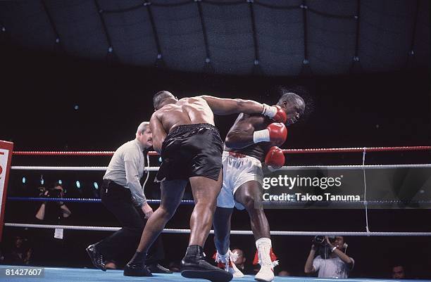 Boxing: WBC/WBA/IBF Heavyweight Title, James Buster Douglas in action, taking punch vs Mike Tyson at Tokyo Dome, Tokyo, Japan 2/11/1990