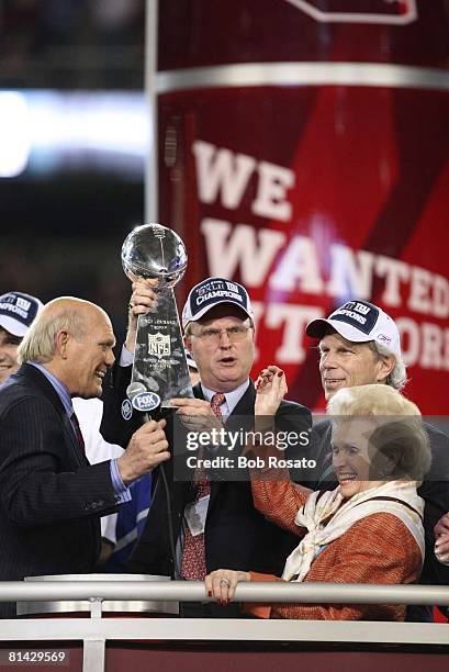 Football: Super Bowl XLII, New York Giants president, CEO, and co-owner John K, Mara victorious, holding Vince Lombardi trophy during celebration...