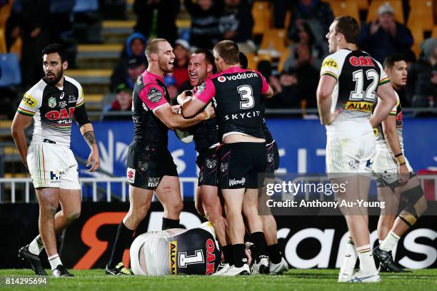 Bodene Thompson of the Warriors celebrates with teammates after scoring a try during the round 19 NRL match between the New Zealand Warriors and the...