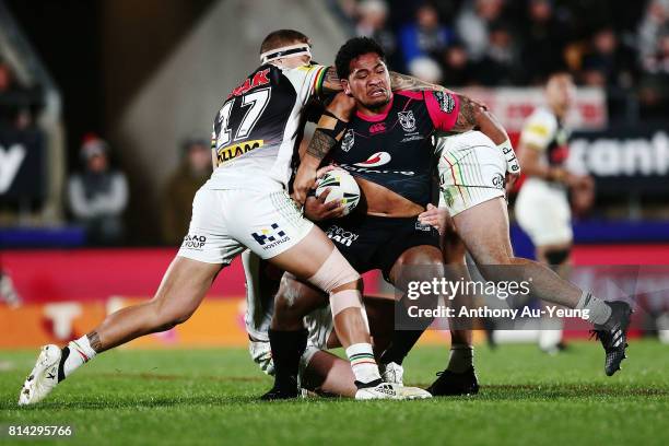 Solomone Kata of the Warriors is tackled by Mitch Rein and James Fisher-Harris of the Panthers during the round 19 NRL match between the New Zealand...