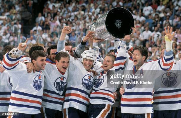 Hockey: Stanley Cup finals, Edmonton Oilers Bill Ranford, Esa Tikkanen, Mark Messier, Wayne Gretzky, and Kevin Lowe victorious with trophy after...