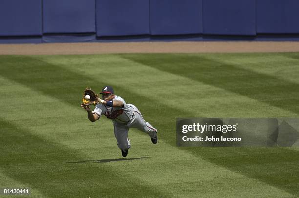 Baseball: Atlanta Braves Andruw Jones in action, diving and fielding catch vs New York Mets, Flushing, NY 4/21/2007