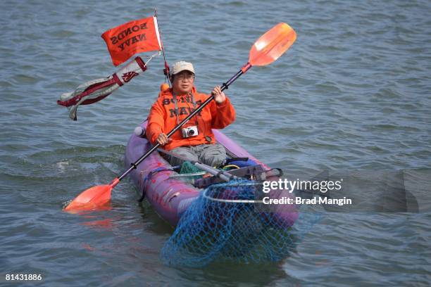 Baseball: San Francisco Giants fan on kayak with BONDS NAVY sign in McCovey Cove during game vs Atlanta Braves, San Francisco, CA 7/26/2007