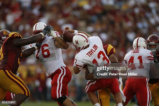 College Football: Nebraska QB Zac Taylor in action during sack by USC Thomas Williams , Los Angeles, CA 9/16/2006