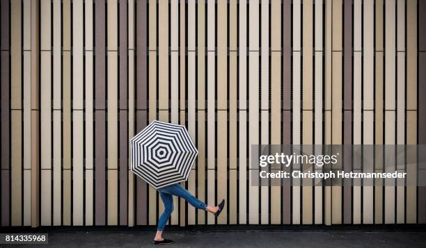 woman with open umbrella - woman on plain background stock pictures, royalty-free photos & images