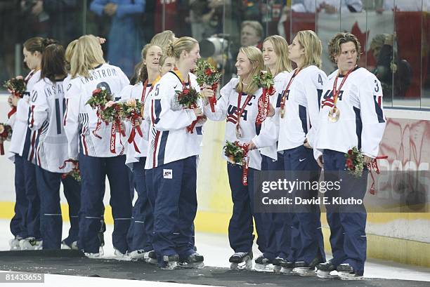 Hockey: 2006 Winter Olympics, USA Lyndsay Wall , Krissy Wendell , and Kathleen Kauth victorious on stand with team during medal ceremony after...