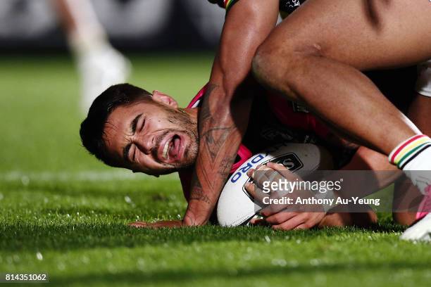 Shaun Johnson of the Warriors shows sign of pain after being tackled by Waqa Blake of the Panthers during the round 19 NRL match between the New...