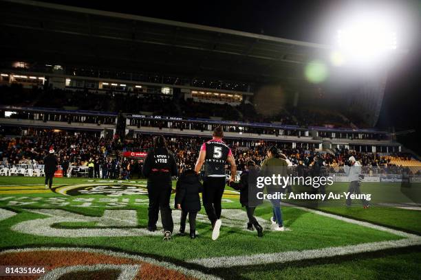 Manu Vatuvei of the Warriors walks across the field with his family to acknowledge the fans prior to the round 19 NRL match between the New Zealand...