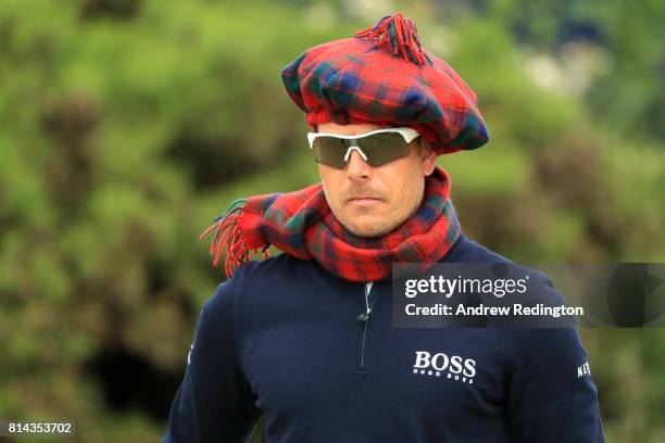 Henrik Stenson of Sweden walks on the putting green wearing a tartan hat and scarf during day two of the AAM Scottish Open at Dundonald Links Golf...