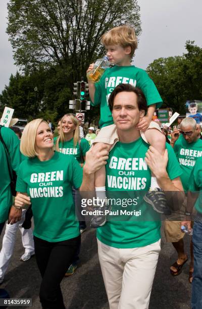 Jenny McCarthy, Evan Asher and Jim Carrey march toward the U.S. Capitol Building at the Green Our Vaccines rally on June 4, 2008 in Washington, DC.