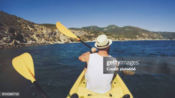 pov of a man kayaking in a summer sea - argentario stock pictures, royalty-free photos & images