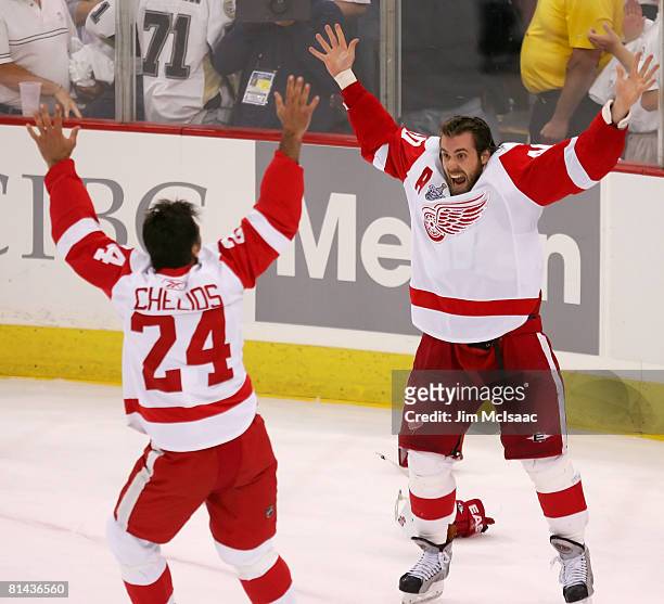 Stanley Cup Playoff MVP, Henrik Zetterberg of the Detroit Red Wings celebrates with teammate Chris Chelios after defeating the Pittsburgh Penguins in...
