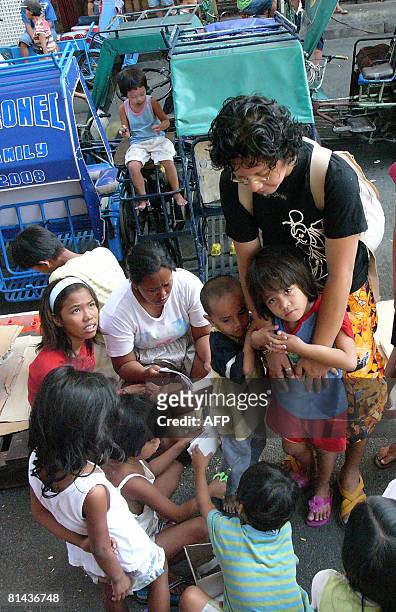 Philippines-homeless-children-streets" by Jason Gutierrez Butch Nerja attends to street children in Manila's sprawling market in Divisoria on April...