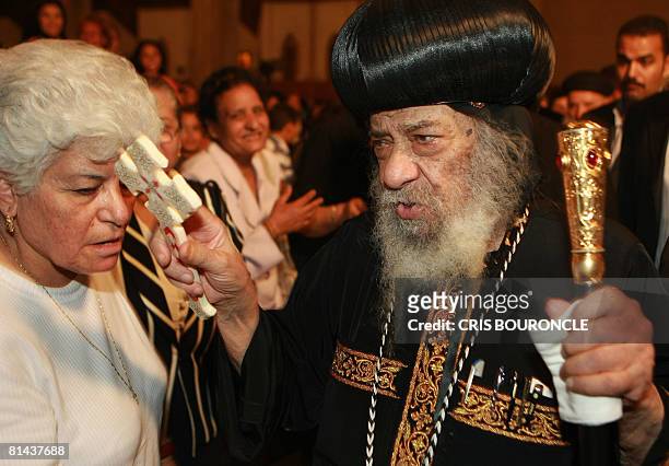 Pope Shenouda III, the 84-year-old head of the Coptic Orthodox Church, Patriarch of Alexandria and the See of St. Mark, blesses members of his...