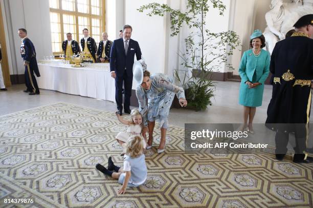 Swedish Princess Madeleine and her husband Christopher O'Neill , Queen Silvia look at Princess Leonore playing with Prince Nicolas at the Royal...