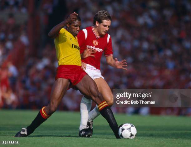 Watford striker Luther Blissett is challenged by Manchester United defender Graeme Hogg during their 1st Division match at Old Trafford, 25th August...