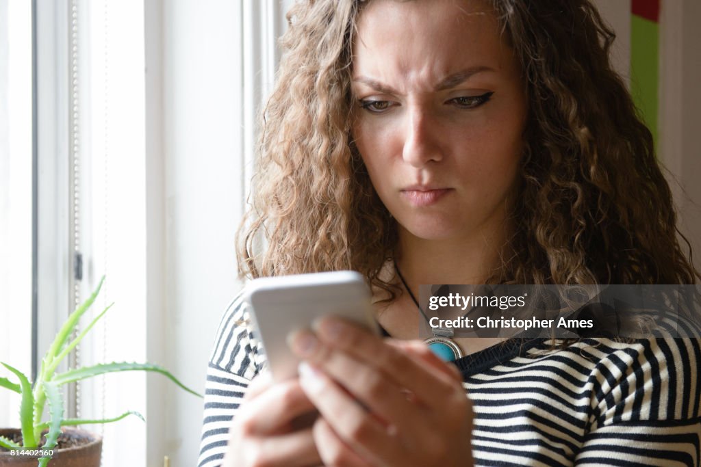 Young Woman Using Smartphone Indoors
