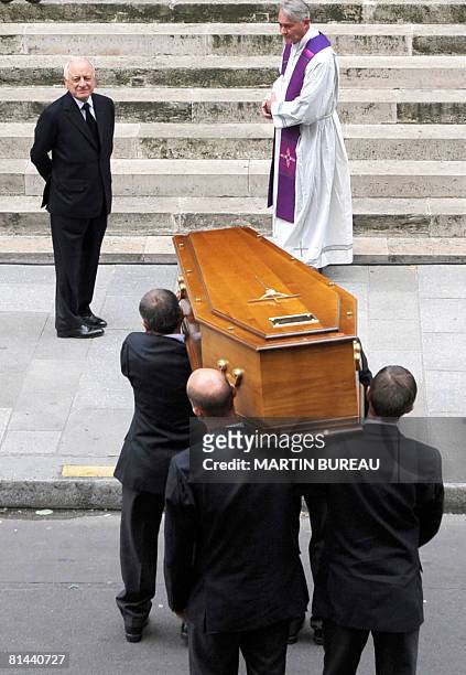Men carry the coffin of French fashion designer Yves Saint-Laurent to Saint-Roch church, on June 5 2008 next to longtime companion Pierre Berge for a...