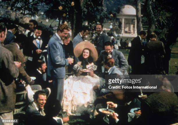 Vivien Leigh as Scarlett O'Hara is surrounded by her beaux in an early scene from the MGM film 'Gone with the Wind'.