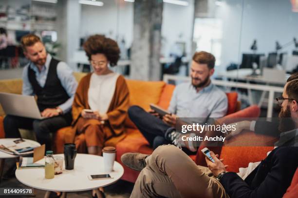 multi-ethnic group of businesspeople drinking coffee during break - hipster office stock pictures, royalty-free photos & images