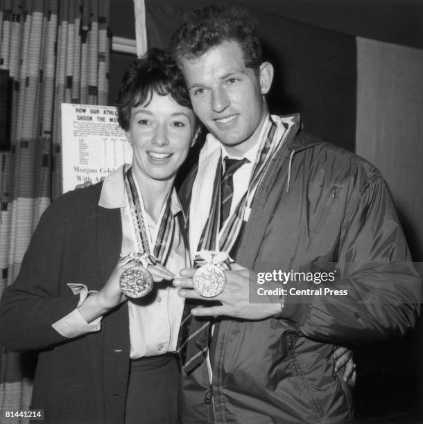 British athletes Ann Packer and her fiance Robbie Brightwell with their medals at London Airport on their return from the Tokyo Olympics, 29th...