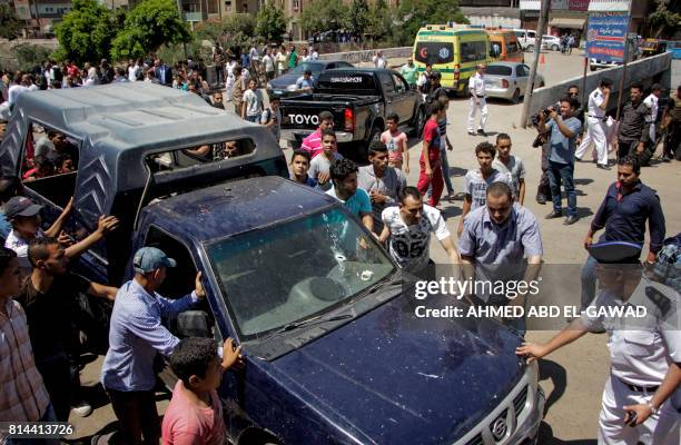 Egyptian policemen inspect the scene of an attack which left five of their colleagues killed in a shooting near Badrasheen, a town some 20 kilometres...