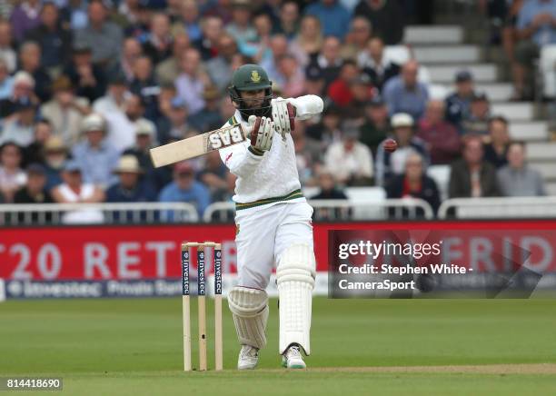 South Africa's Hashim Amla hits a boundary of the bowling of England's Mark Wood and becomes the fifth South African batsman to reach 8000 test runs...