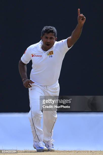Sri Lankan cricketer Rangana Herath celebrates after taking a wicket during the first day of the only Test cricket matcth between Sri Lanka and...