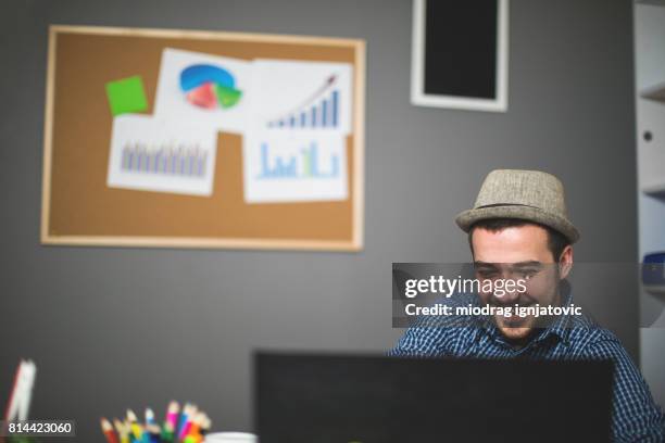 young man working at the office - online bulletin board stock pictures, royalty-free photos & images