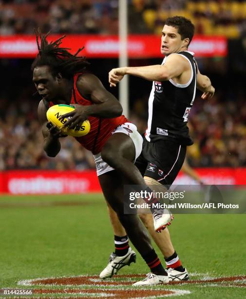 Anthony McDonald-Tipungwuti of the Bombers and Leigh Montagna of the Saints compete for the ball during the 2017 AFL round 17 match between the St...