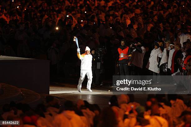 Opening Ceremony: 2006 Winter Olympics, Former Italian skier Alberto Tomba carrying Olympic torch before games, Torino, Italy 2/10/2006