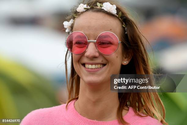 Festival goer dressed in the festival theme of 'hippie' poses in Carhaix-Plouguer, western France on July 14 during the second day of the 26th...