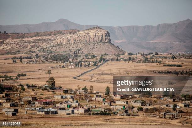 Picture taken on June 2, 2017 shows a general view of a Lesotho village on the outskirts of Maseru, Lesotho. - The red tape of South Africa's...