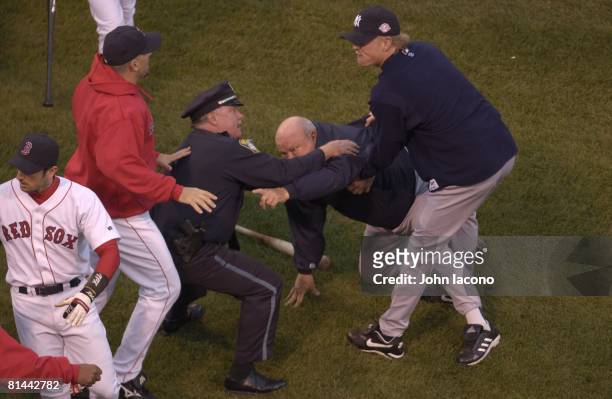 Baseball: ALCS Playoffs, New York Yankees bench coach Don Zimmer upset, getting held by police after fight with Boston Red Sox Pedro Martinez during...