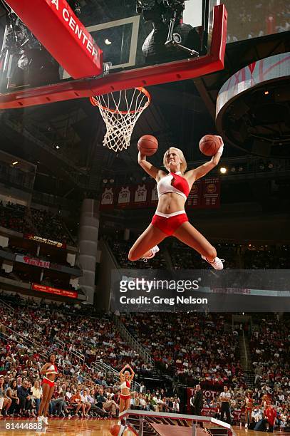 Basketball: Houston Rockets dance team cheerleader Carrie Barnhart making dunk from trampoline during game vs New York Knicks, Houston, TX