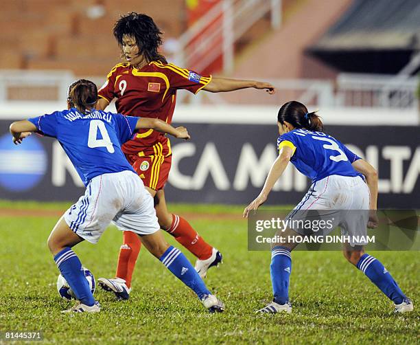 Chinese forward Han Duan leads an attack as Japanese defenders Azusa Iwashimizu and Hiromi Ikeda try to stop during the AFC Women's Asian Cup...