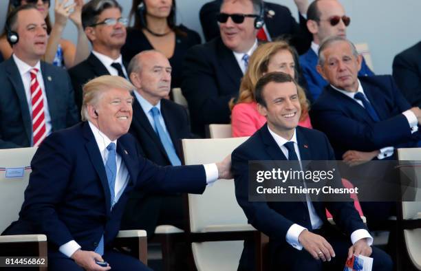 President Donald Trump and French President Emmanuel Macron attend the traditional Bastille day military parade on the Champs-Elysees on July 14,...