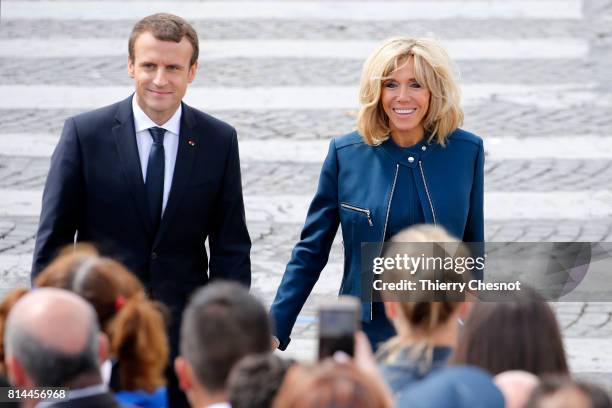 French President Emmanuel Macron and his wife Brigitte Trogneux attend the traditional Bastille day military parade on the Champs-Elysees on July 14,...